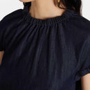 Comfortable Women’s Denim Top – Casual Short Sleeve Daily Wear Navy blue top worn by a person on a light gray background